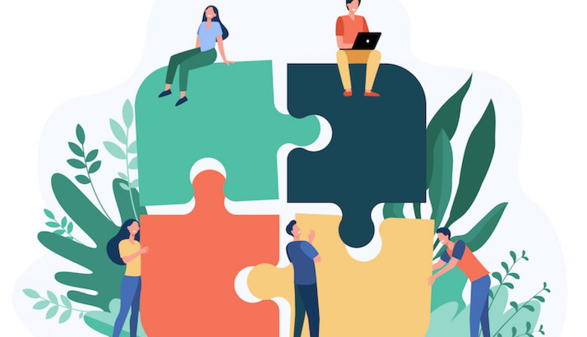 Business team putting together jigsaw puzzle